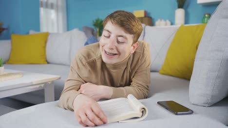 Young-man-having-a-good-time-reading-a-book.-Happy-young-man.